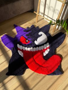 a rug that looks like a monster with big teeth and fangs on it's face