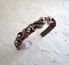 "Copper Tube, hammered, textured and shaped. Copper wire is added in a chaotic way with White Crystal and copper bead accents. This is a stock Photo. All bracelets will look very much like this bracelet. Size: 1/2\" x 6\" Matching Earrings and Pendant also available. Also sold in a Set. https://www.etsy.com/listing/586848762/wedding-jewelry-set-copper-cuff-bracelet?ref=shop_home_active_1 I have great pride in my collection and want you to be happy with your purchase. Please carefully review the Rustic Wedding Jewelry, Blue Pendant Necklace, Copper Anniversary Gifts, Vintage Wedding Jewelry, Copper Gifts, Bracelet Wedding