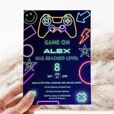 a person holding up a card that says game on alex has reached level in front of them