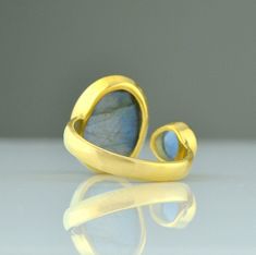 This beautiful open ring features two natural gemstones - one large oval aqua chalcedony and small round blue topaz set in either sterling silver or in 18K Vermeil Gold. Large oval stone is 18 x 12 mm. Small round stone is is 6mm. Please choose: ✦ METAL - 18K Vermeil gold ✦ SIZE Ring is adjustable. Comes in 3 sizes: small - size 5-6 medium - size 7-8 large - size 9-10 Please specify your choice of size and metal at the checkout. Since we use natural gemstones, the stones may vary slightly in col Double Stone Ring, Gold Vermeil Jewelry, Bezel Set Ring, Ring Bezel, Aqua Chalcedony, Set Ring, Vermeil Jewelry, Ring Oval, Ring Gemstone