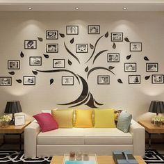 a living room filled with furniture and framed pictures on the wall above a white couch