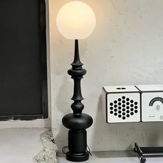 a lamp sitting on top of a table next to a box