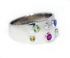 Create a comfortable mother's ring you can wear daily. Each gemstone is handset in a bezel setting to provide a smooth design. The gemstone are different sizes to represent each generation of grandmother, mother, children and grand-children. Contact us to learn more about our custom design services. DETAILS Material: Sterling Silver Synthetic gemstones 10mm tapered band Modern White Gold Birthstone Ring With Bezel Setting, Modern Round Gemstones For Anniversary, Modern Gemstones For Anniversary, Modern Birthstone Gemstones For Anniversary, Modern Anniversary Birthstone Gemstones, Modern Multi-stone Gemstones For Anniversary, Modern Multi-stone Sapphire Anniversary Ring, Modern Multi-stone Birthstone Ring For Gift, Modern Multi-stone Birthstone Ring For Anniversary