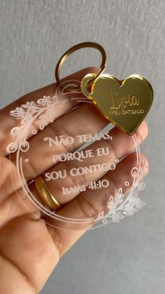 a person holding a heart shaped keychain with the words i love you written on it