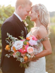 a bride and groom pose for a wedding photo