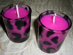 two purple candles with black spots on them