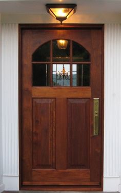 a wooden door with two sidelights on the outside