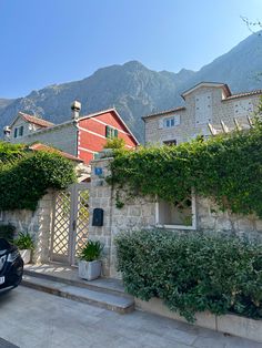 a car parked in front of a house with vines growing on the side of it