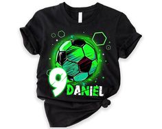 a black t - shirt with a green soccer ball and the number nine on it