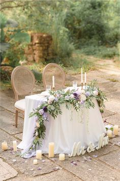 a table with candles and flowers on it