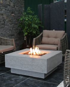 an outdoor fire pit sitting on top of a patio