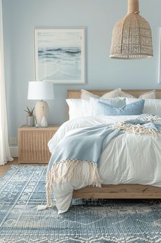 a bedroom with blue walls and white bedding, wicker lamps and pictures on the wall