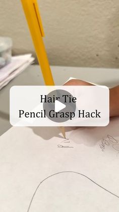 a person is writing on paper with a pencil in their hand and the words hair tie pencil grasp hack