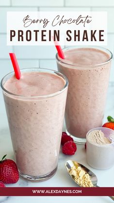 two glasses filled with berry chocolate protein shake on top of a white table next to strawberries