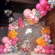 balloons and streamers decorate the backdrop for an event