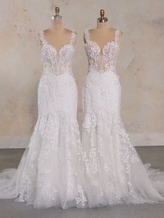 two wedding dresses on mannequins in front of a wall