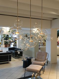 a living room filled with furniture and lots of bubbles hanging from it's ceiling