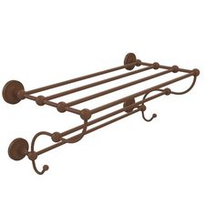 a black metal shelf with three hooks on it