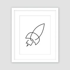 a black and white drawing of a rocket ship in a square frame on a wall