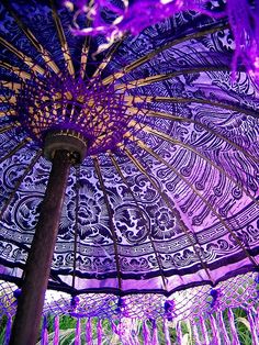 the inside of an umbrella with purple flowers on it