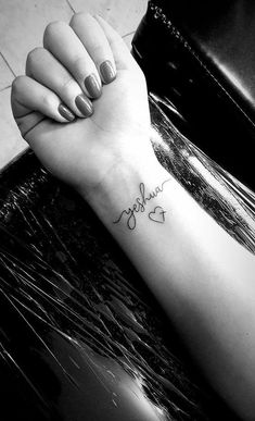 a woman's arm with a tattoo that reads, love is in the air