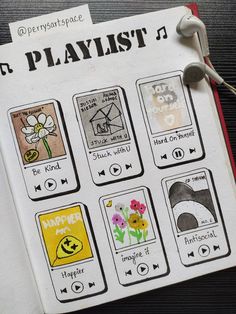 an open notebook with various stickers on it and headphones attached to the pages