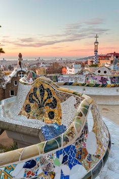 an artisticly designed bench on top of the roof of a building in barcelona, spain