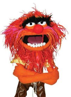 the muppet is standing with his arms crossed and eyes wide open while wearing boots