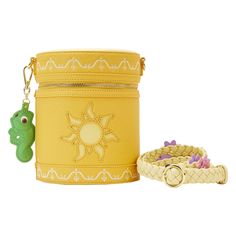 a yellow box with a keychain and a small green bag next to it