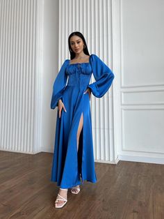 Unveil your style with this striking blue maxi dress, crafted from luxurious dense Italian silk satin. Featuring an elegant off-shoulder neckline, corset-style bodice with adjustable drawstrings, and long voluminous sleeves, this gown is perfect for formal events, parties, or special occasions. The flowing skirt with a high slit adds a touch of drama, making this dress both sophisticated and bold. Details: - Fabric: Dense Italian silk satin - Color: Royal Blue - Design: Off-shoulder with adjustable bust - Sleeve: Long voluminous sleeves - Skirt: Maxi length with high thigh slit - Ideal for formal events, weddings, and special gatherings Embrace luxury and elegance with every step in this timeless piece that combines comfort and allure. Size XS: - Bust up to 89 cm (35 inches) - Waist up to Blue Wedding Guest Dresses, Style Corset, Blue Evening Gowns, Silk Satin Fabric, Voluminous Sleeves, Blue Maxi Dress, Blue Dress Formal, Blue Evening Dresses, Royal Blue Dresses