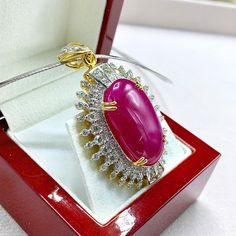 "This gorgeous, vivid, HUGE CABOCHON-Shaped, Burmese Ruby and stunning, impeccably graded F/VS Diamonds will totally melt everyone's heart! EXTREMELY RARE ENORMOUS 40.89 CARATS BURMESE RUBY with ATTRACTIVE, VIVID, HOT-PINKISH-RED color. SET IN FINE 18K SOLID YELLOW GOLD HANDCRAFTED PENDANT! ONLY ONE ITEM AVAILABLE!! WHAT YOU SEE IN THE PICTURES IS WHAT YOU WILL GET   \"You will get the best GEMSTONES from the most experienced GEMS wholesaler in the world.\" SUGGESTED RETAIL VALUE: $35,000 RUBY: Exquisite Gia Certified Jewelry Gift, Dazzling Ruby Necklace For Gift, Exquisite Ruby Jewelry Gia Certified, Luxury Gia Certified Gold Necklaces, Luxury Red Cabochon Necklaces, Luxury Red Cabochon Necklace, Luxury Ruby Oval Pendant Jewelry, Ruby Cabochon Pendant Jewelry, Gia Certified Yellow Gold Necklace Gift