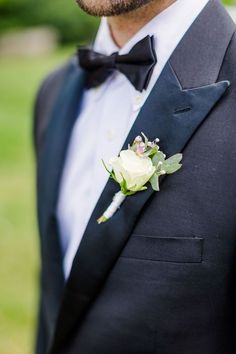 a man in a tuxedo with a boutonniere on his lapel