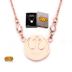 a necklace with a star wars symbol on the front and a box in the back