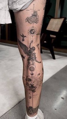 a man's leg with tattoos on it