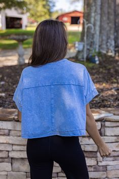 women's blue cropped basic tee The Easy Does It Blue Crop Tee will be your go-to for effortless style. This washed blue tee features an easy, cropped fit with a boxy silhouette for a comfortable and casual look. Perfect to pair with your black yoga or jogger pants! True to size Model is 5'3" wearing a small Semi cropped boxy fit Very soft Raw hem Fabric contains stretch Small length: 18.5" Small bust: 55" 100% cotton