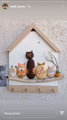 a cat house with five cats sitting on it's shelf, and one cat is looking at the camera