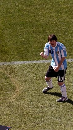 a man standing on top of a field next to a soccer ball