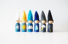 a row of small wooden toy figures with different colors