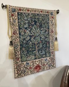 a tapestry hanging on the wall with tassels