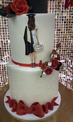 a three tiered cake with red flowers on the side and an image of a woman holding a purse