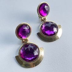 Vintage clip on earrings  Gold tone metal  Please See Pictures for size and details  Free Gift wrapping upon request Free Shipping on orders over $35 (Domestic) For more treasures please visit: https://www.GlowingEmpire.com Formal Round Metal Clip-on Earrings, Brass Dangle Clip-on Earrings, Purple Clip-on Earrings, Round Metal Clip-on Plug Earrings, Purple Clip-on Earrings For Formal Occasions, Metal Drop Clip-on Earrings For Anniversary, Formal Metal Clip-on Earrings, Vintage Clip On Earrings, Vogue Beauty