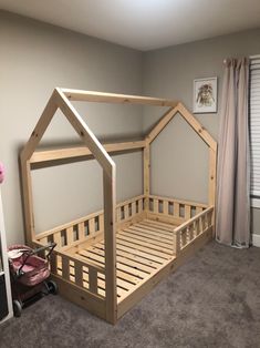 a wooden bed frame in a room with carpet