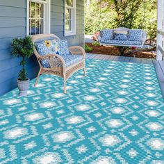 a porch with blue and white rugs on it