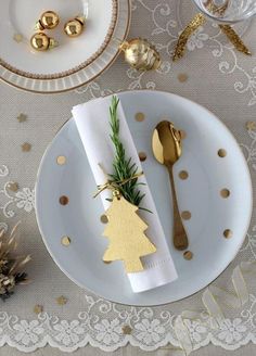 a white plate topped with gold christmas decorations