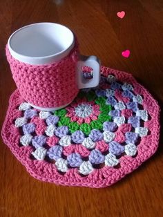 a crocheted coaster with a coffee cup on it and a mug in the middle