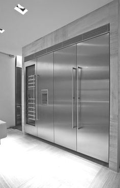 a stainless steel refrigerator in the middle of a room