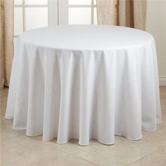 a round table with white cloth on it