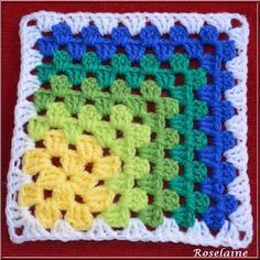 a crocheted square with different colors on it