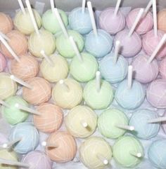 a box filled with lots of different colored lollipops and marshmallows