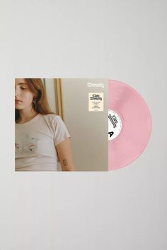 a pink vinyl record with an image of a woman